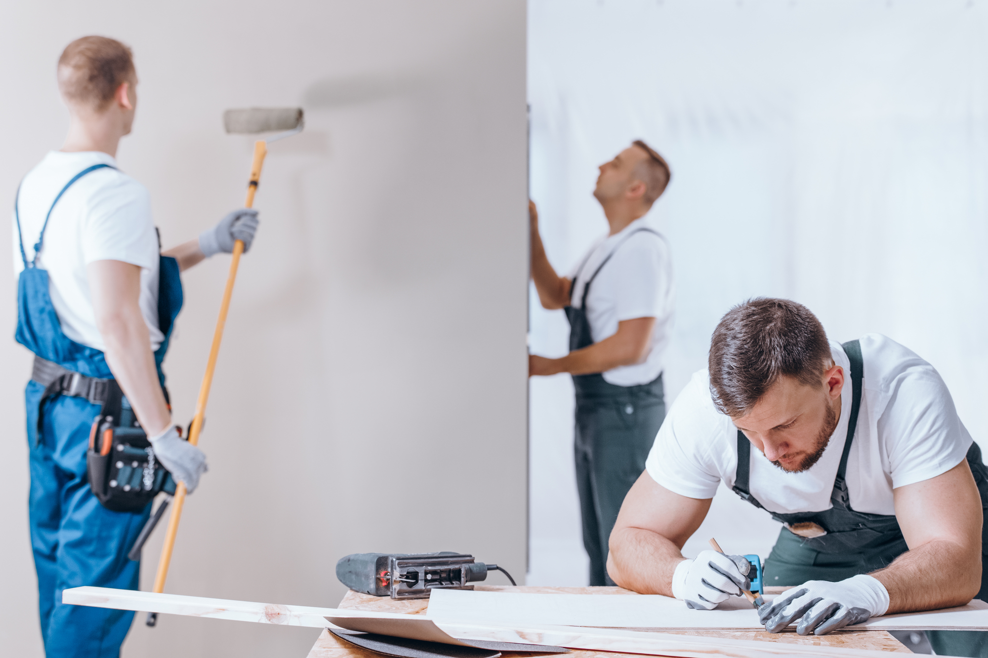 Workers Finishing Work Inside New Renovated Room